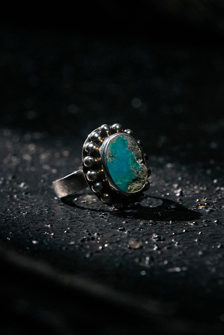 Ring with a turquoise stone on a dark surface
