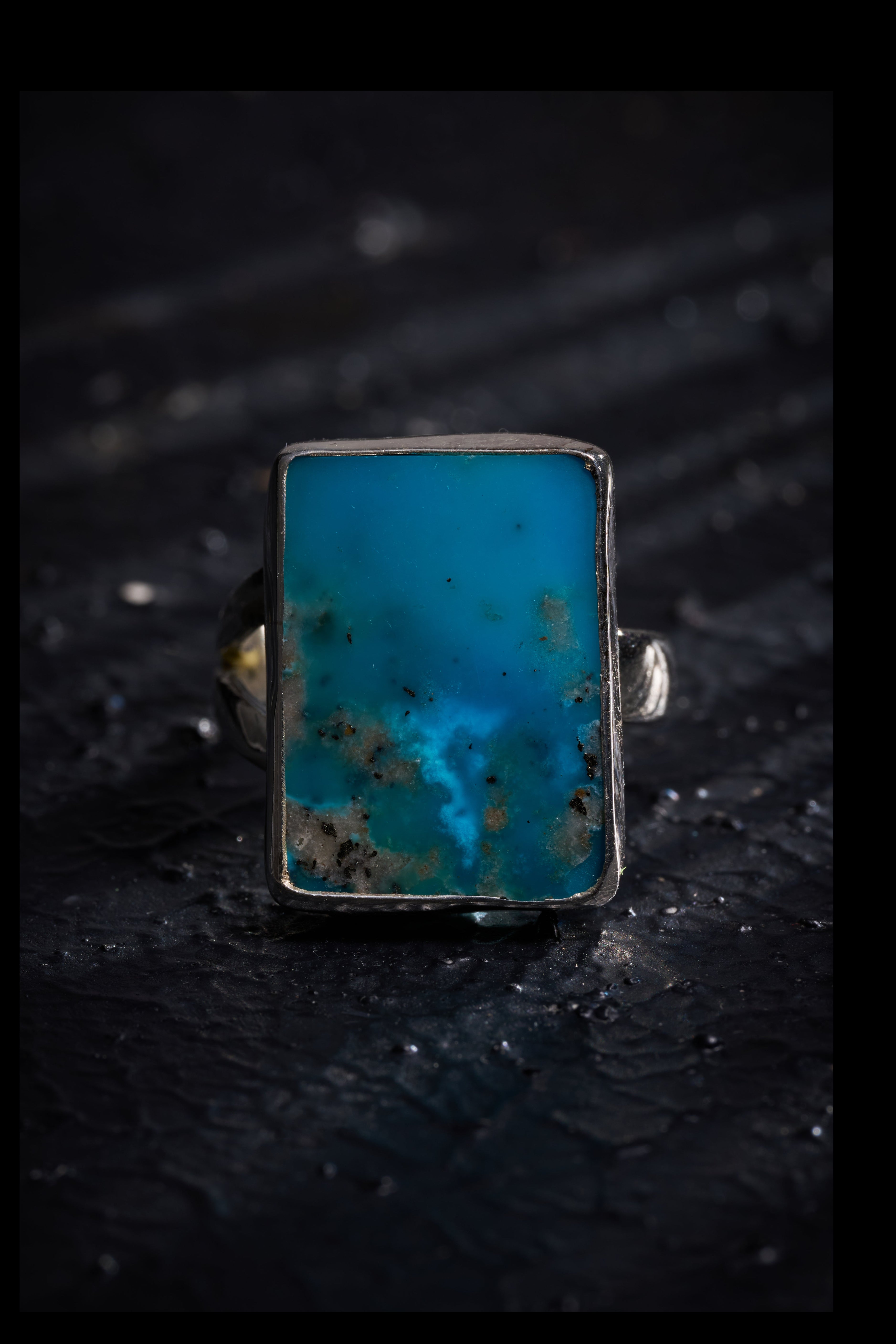 Silver ring with a rare turquoise stone with a genie spirit shape