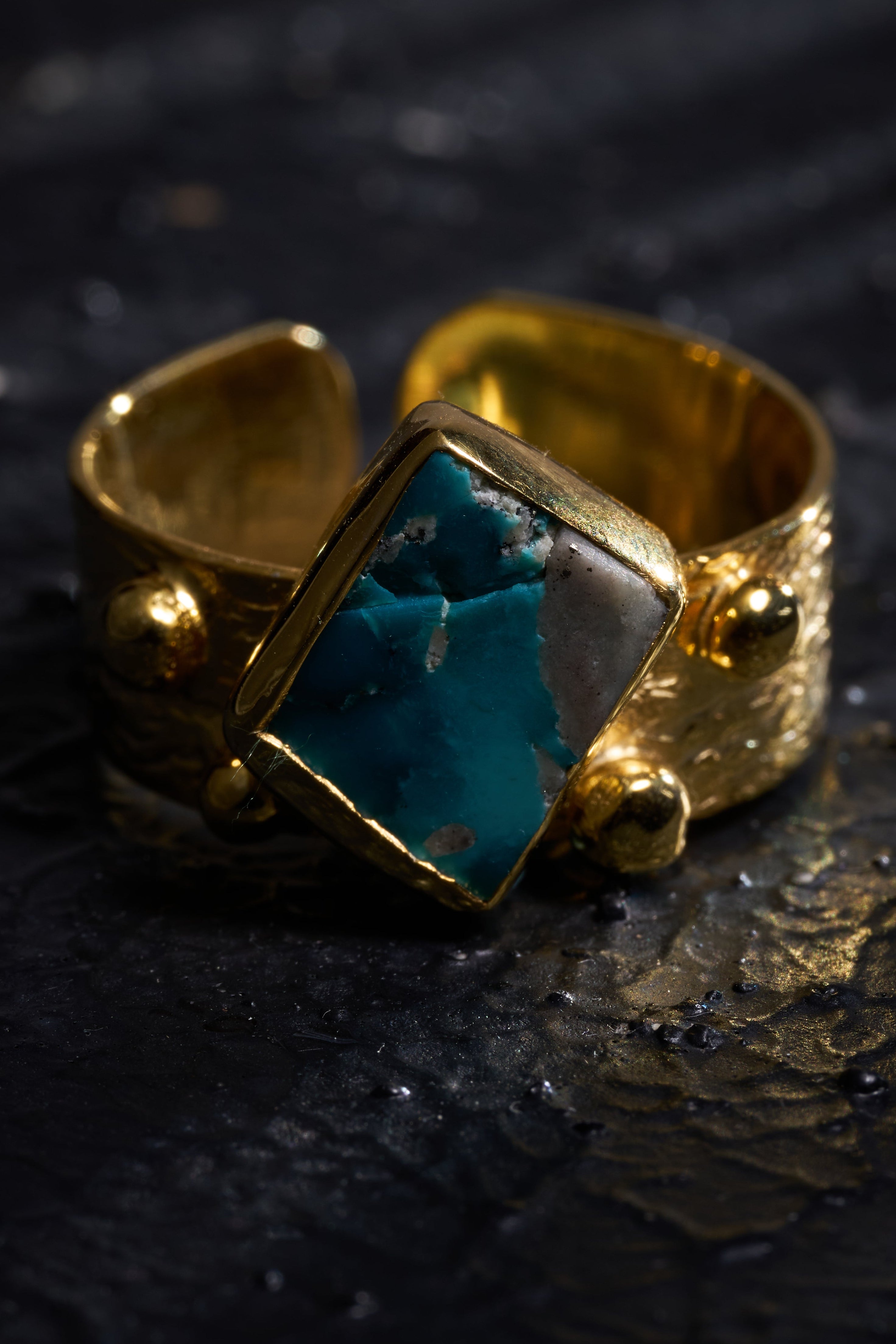 Silver  ring with a turquoise stone on a dark textured surface