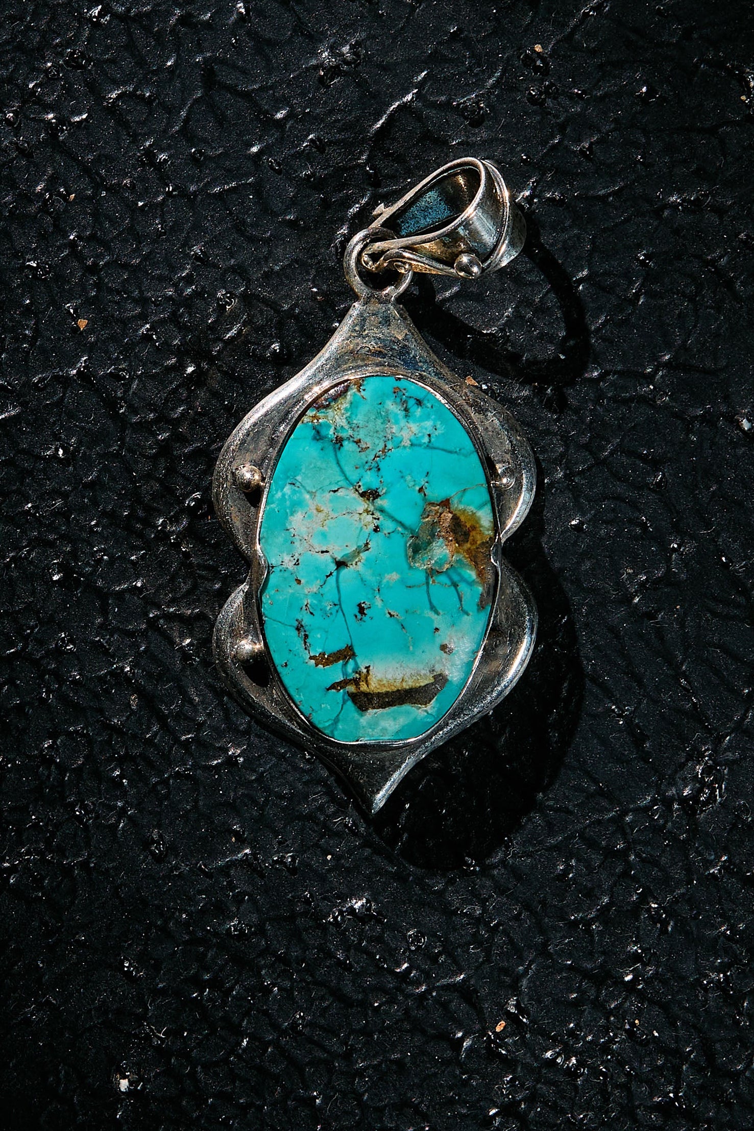 Turquoise pendant on 925 silver on a black background