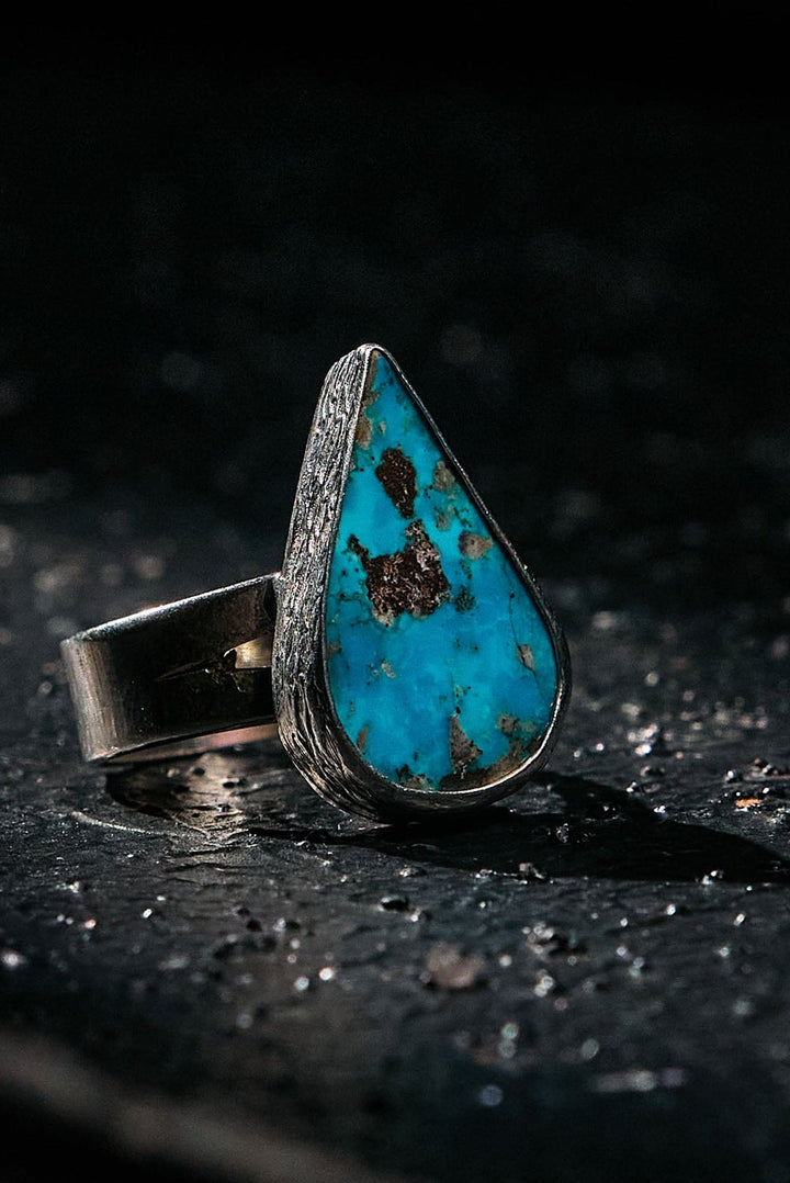 Turquoise ring onn 925 silver with a dark background