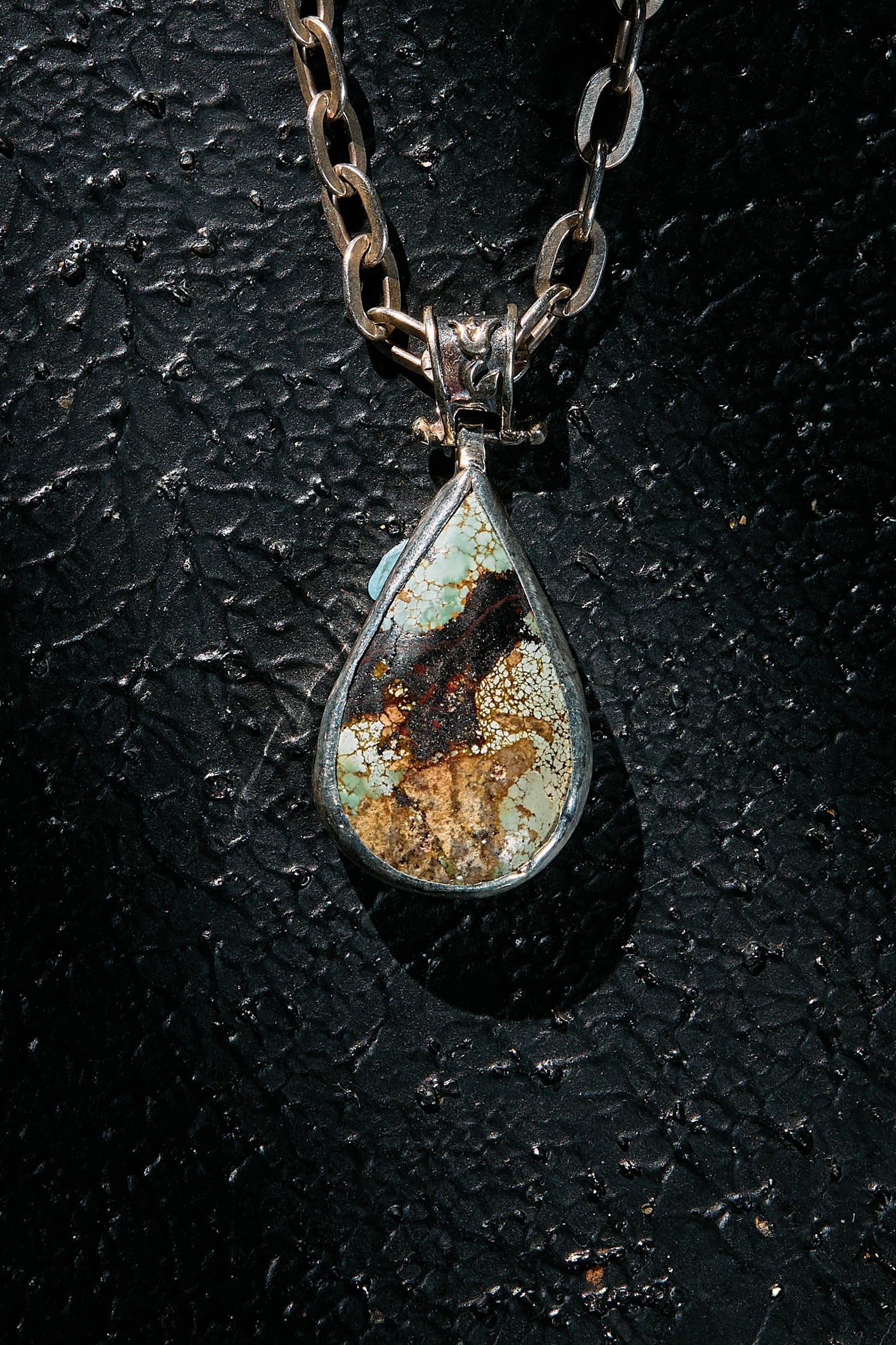 Teardrop-shaped natural turquoise pendant necklace with a textured chain