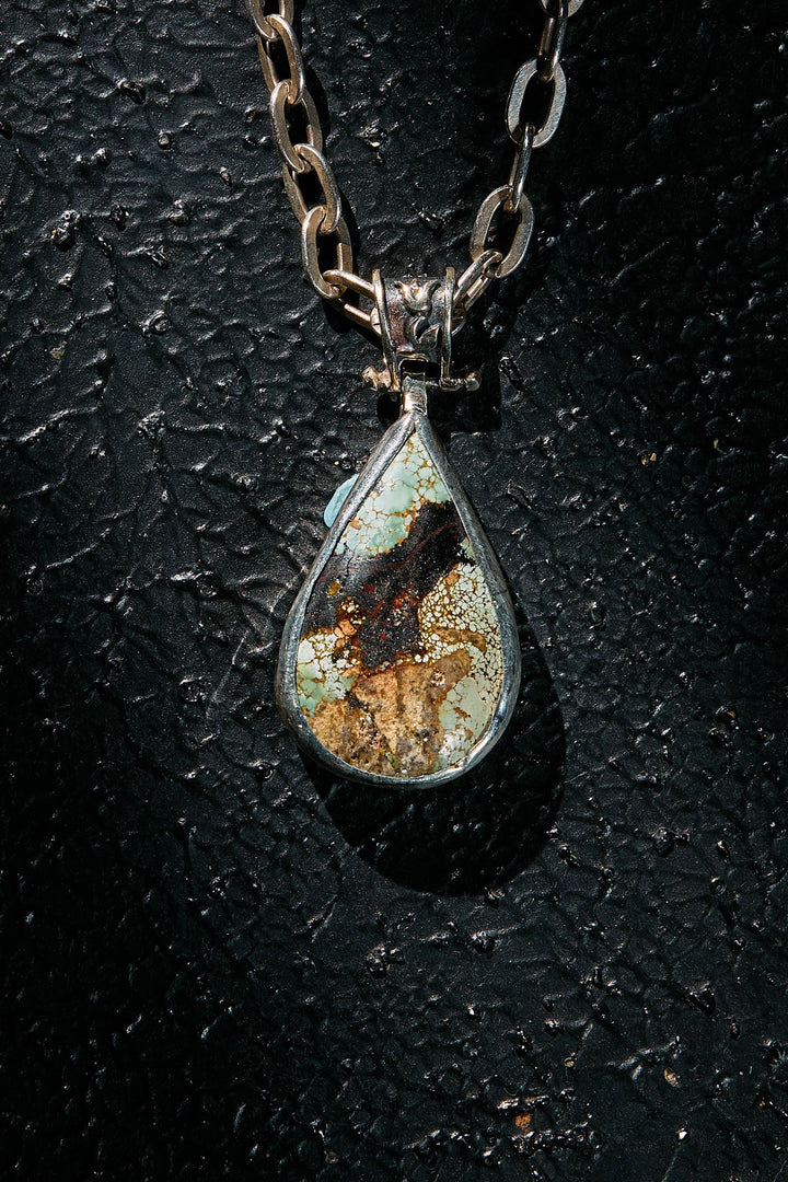 Teardrop-shaped natural turquoise pendant necklace with a textured chain