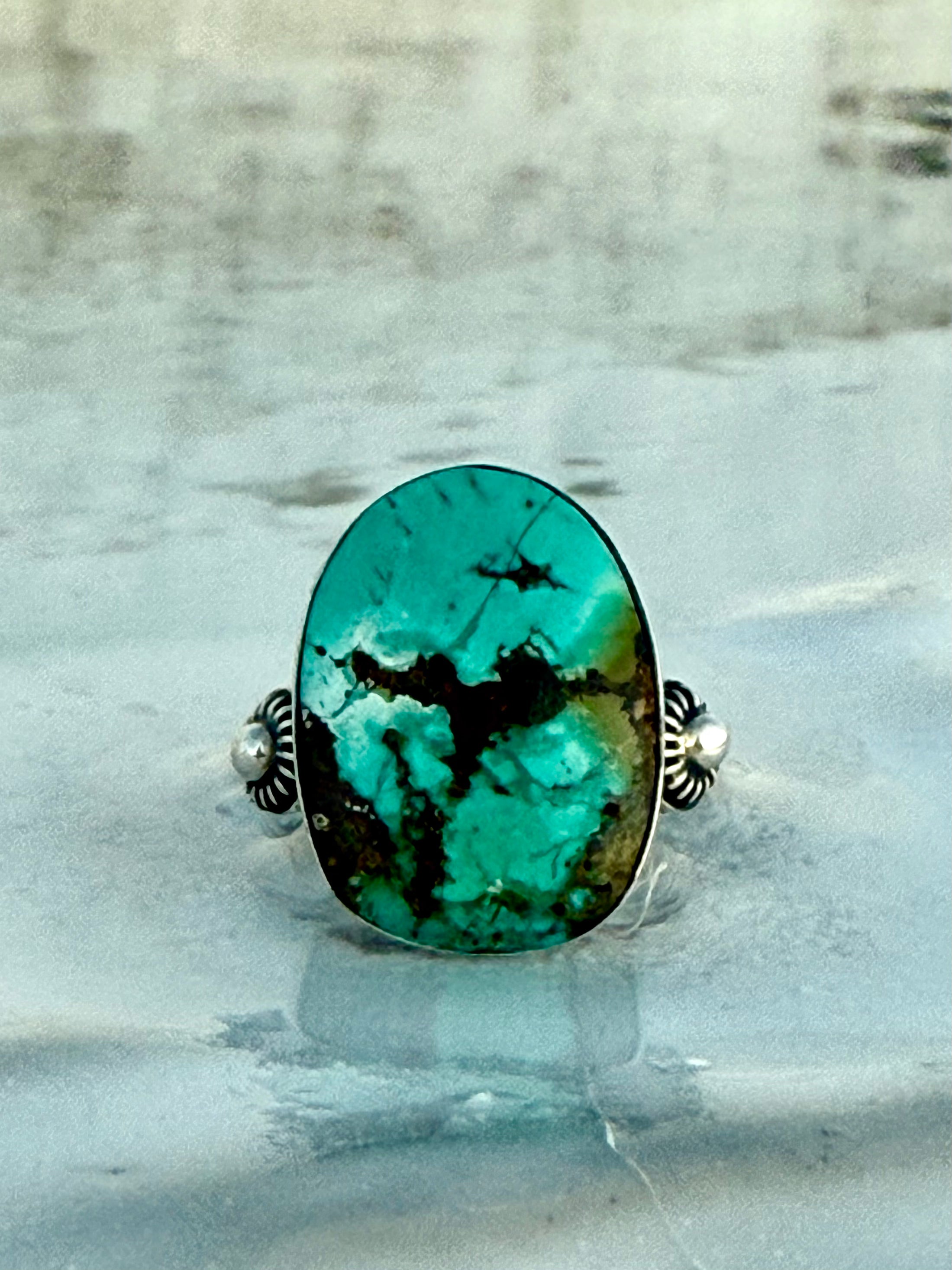 Ring with a large turquoise stone with an incredible natural matrix of a seadragon