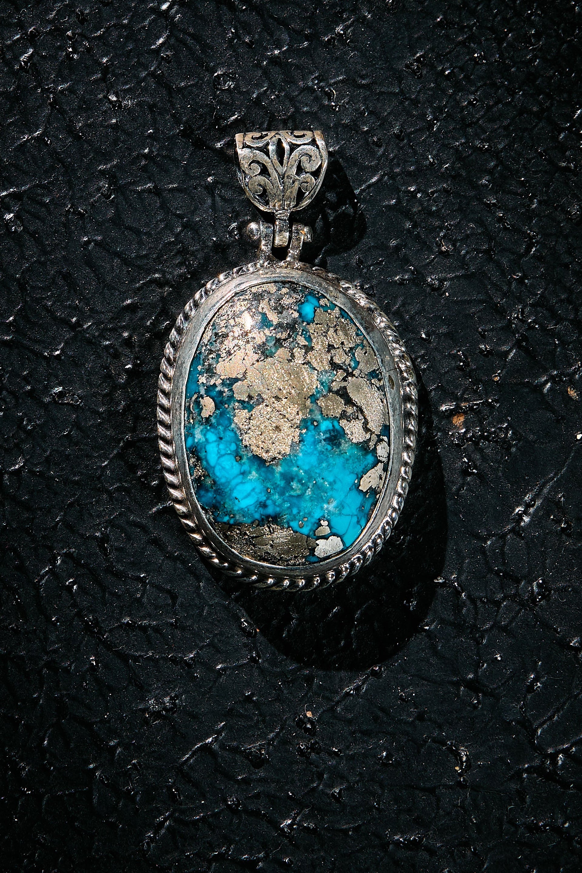 Silver pendant with a rare turquoise silver matrix within