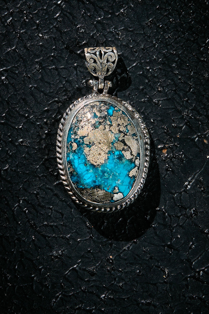 Silver pendant with a rare turquoise silver matrix within