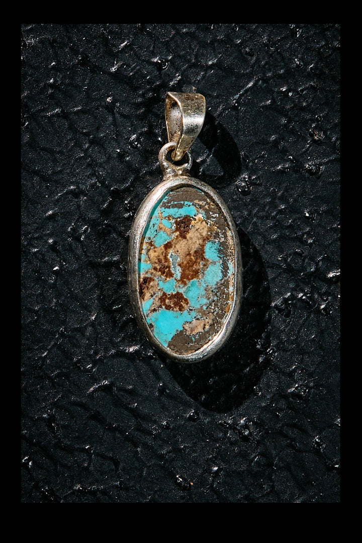 Turquoise stone pendant in a silver setting