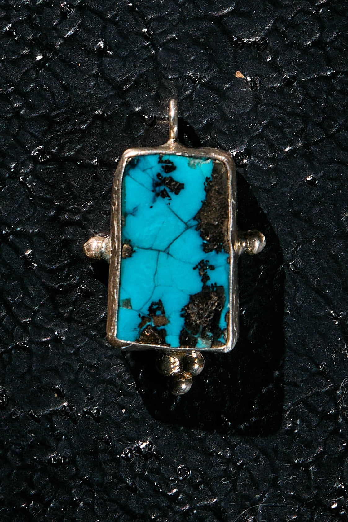 Turquoise pendant with a silver tribe in the matrix, on 925 silver