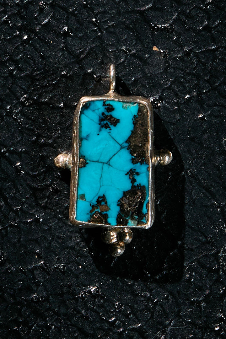 Turquoise pendant with a silver tribe in the matrix, on 925 silver